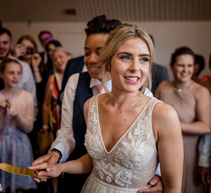 Two Brides Cutting the Traditional Wedding Cake