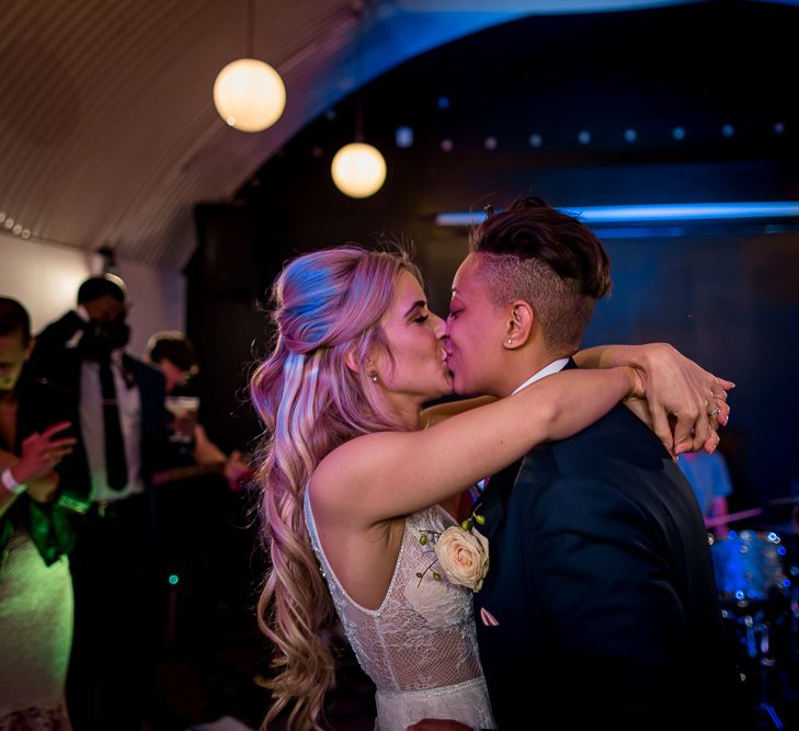 Bride and Bride Kissing on the Dance Floor During First Dance