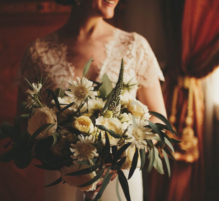 Bride in lace detail Sarah Seven wedding dress with white bouquet