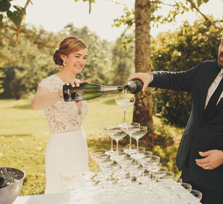 Bride in Sarah Seven dress with new husband with Champagne tower