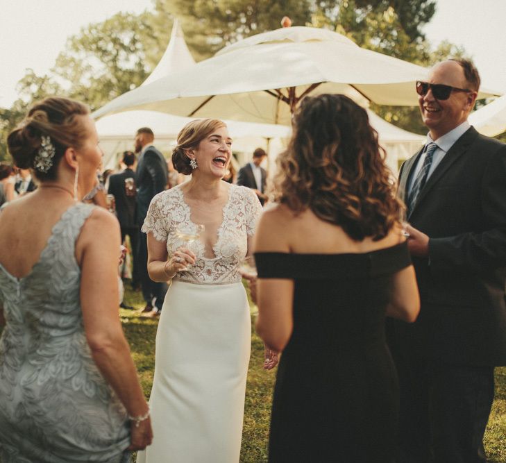 Bride in Sarah Seven wedding dress talking to guests