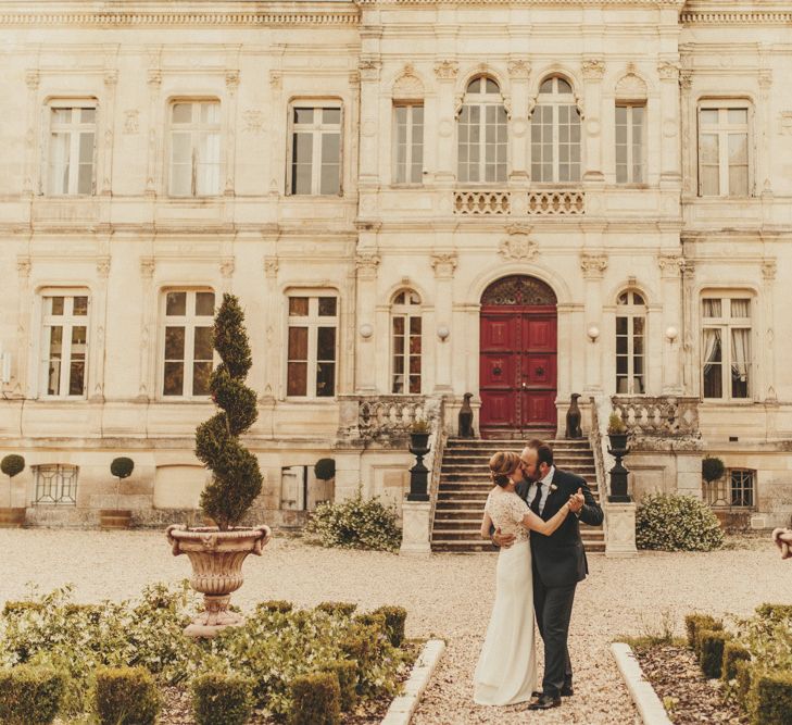 Bride in Sarah Seven wedding dress with groom at French wedding venue