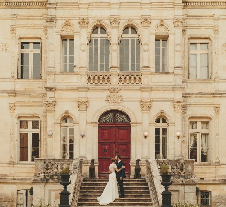 Bride in Sarah Seven wedding dress with groom at French wedding venue