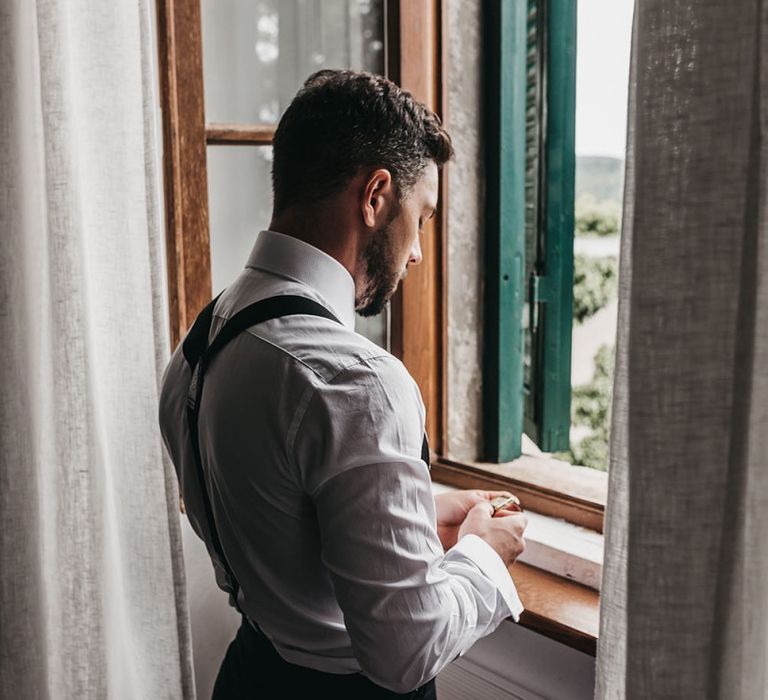 Groom preparations for black and white Italian wedding