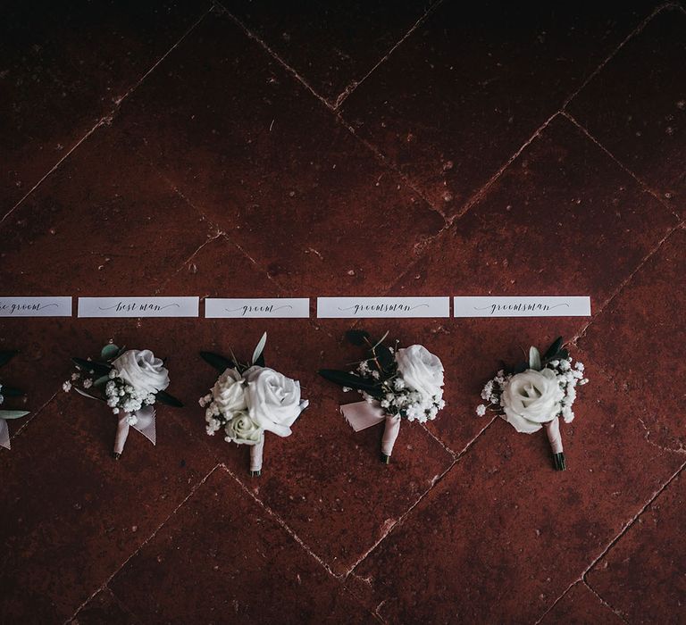 Buttonholes for groom and groomsmen at black and white wedding