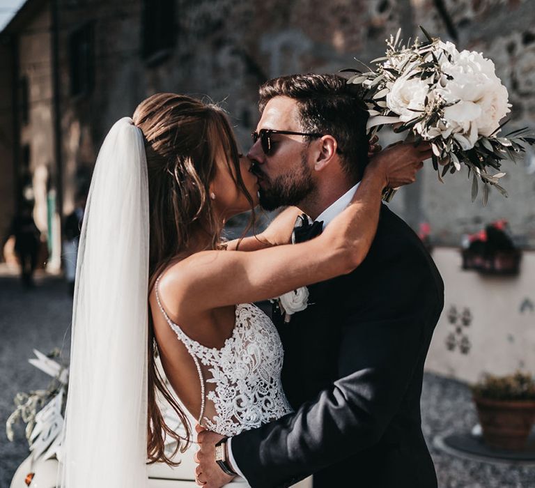 Bride and groom steal a kiss during reception