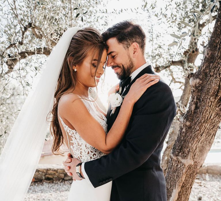 Lace detail wedding dress with groom in tuxedo for black and white wedding in Italy