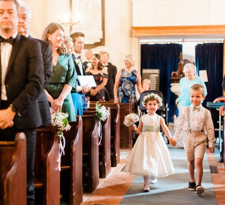 Bridesmaid and page boy walk down the aisle