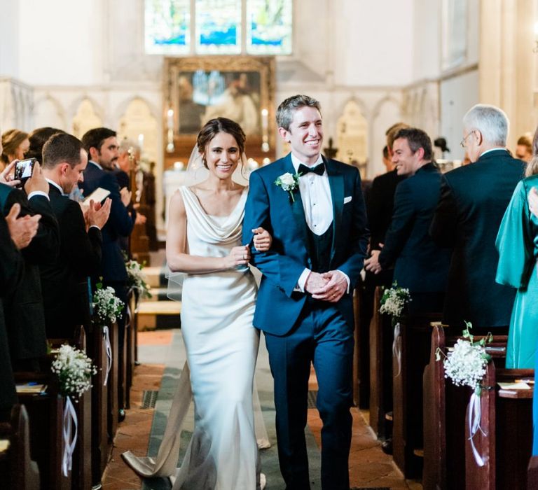 Bride and groom walk down the aisle as husband and wife