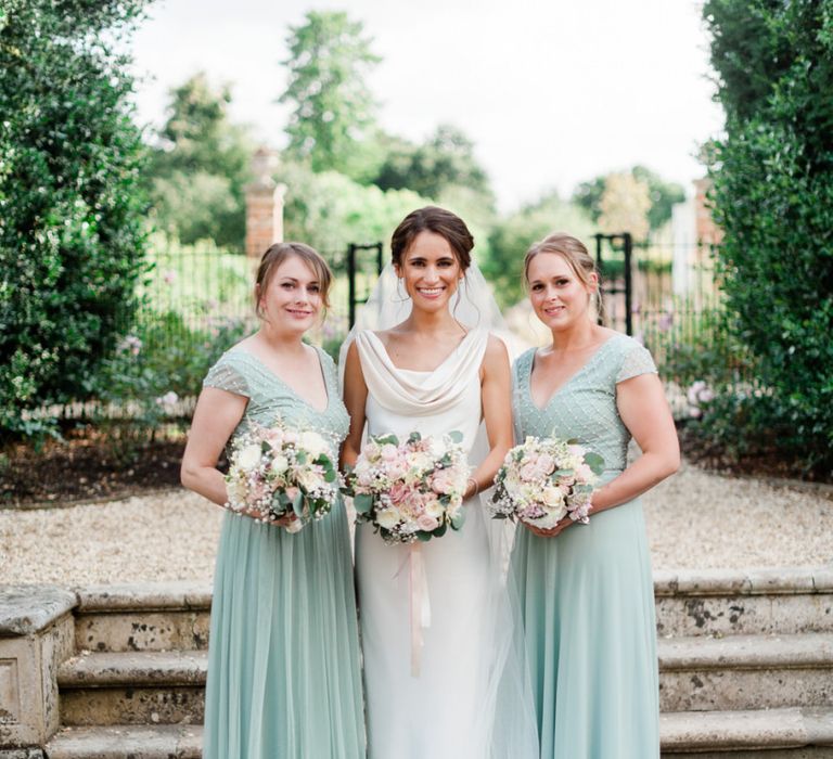 Mint green bridesmaid dresses with blush bouquets