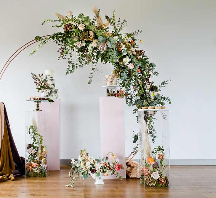 Floral Arch And Perspex Plinth For Wedding Cake Display // Environmentally Conscious Wedding Venue Casterley Barn In Wiltshire Organic Working Farm Stylish Barn Wedding Venue Images Lydia Stamps