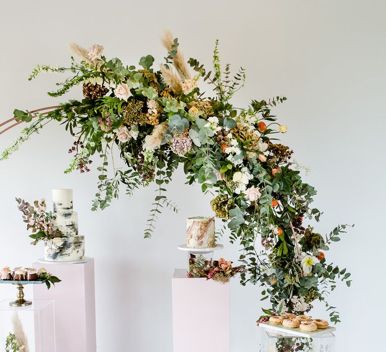 Floral Arch And Perspex Plinth For Wedding Cake Display // Environmentally Conscious Wedding Venue Casterley Barn In Wiltshire Organic Working Farm Stylish Barn Wedding Venue Images Lydia Stamps