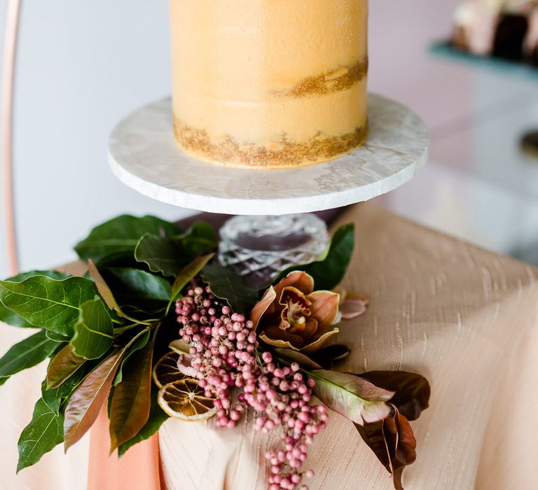 Floral Arch And Perspex Plinth For Wedding Cake Display // Environmentally Conscious Wedding Venue Casterley Barn In Wiltshire Organic Working Farm Stylish Barn Wedding Venue Images Lydia Stamps