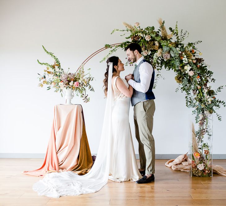 Elegant Pastel Modern Wedding Inspiration With Floral Arch Ceremony Backdrop // Environmentally Conscious Wedding Venue Casterley Barn In Wiltshire Organic Working Farm Stylish Barn Wedding Venue Images Lydia Stamps