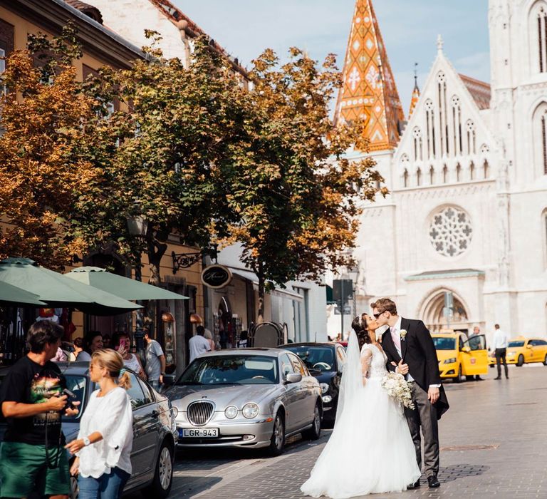 Bride and Groom Kissing in the Street in Budapest