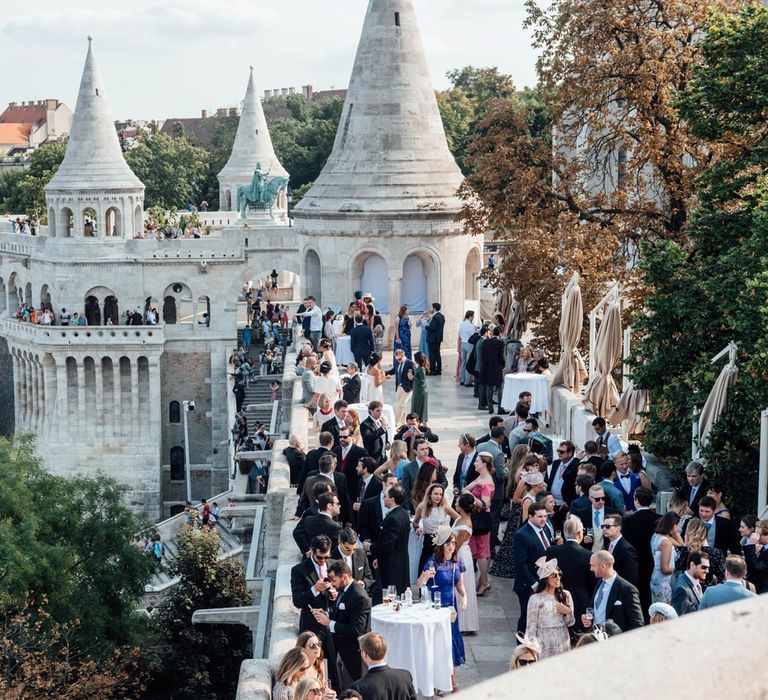 Wedding Guests Gathered on the Veranda for a Drinks Reception