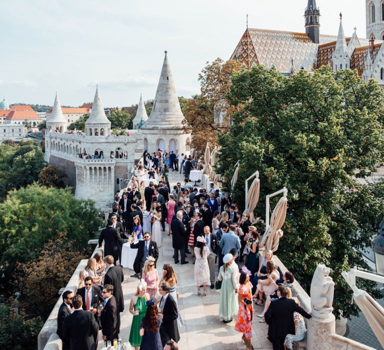 Wedding Guests Gathered on the Veranda for a Drinks Reception