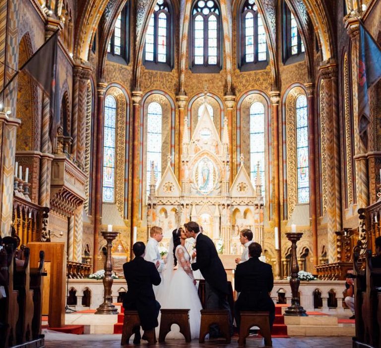 Bride and Groom Kissing at the Altar at Matthias Church in Budapest