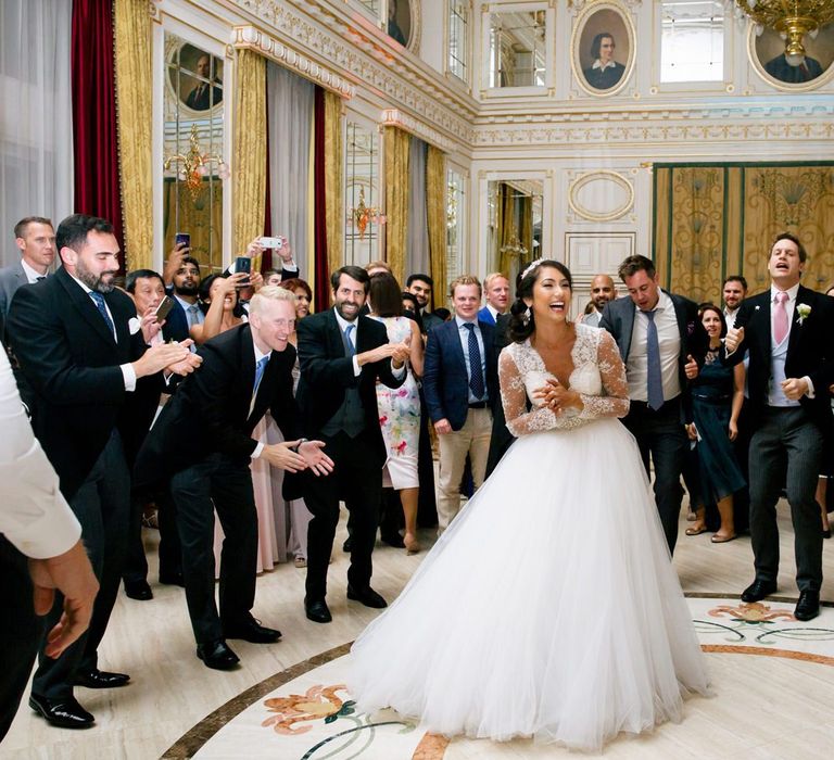 Bride in Pergola Rosa Clara Princess Wedding Dress Surrounded by The Groomsmen on the Dancefloor