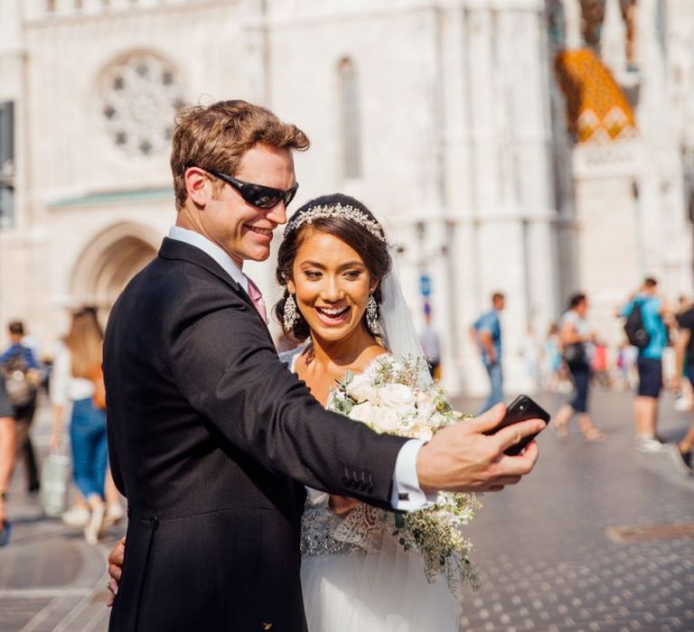 Bride in Pergola Rosa Clara Princess Wedding Dress and Groom in Traditional Morning Suit Selfie