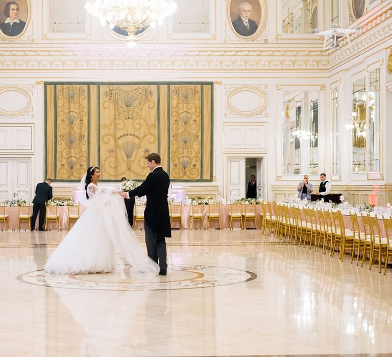 Bride in Pergola Rosa Clara Princess Wedding Dress and Groom in Traditional Morning Suit Standing in the Middle of Their Wedding Reception