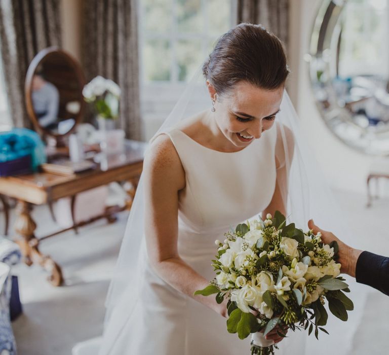 Bride holding her white and green wedding bouquet