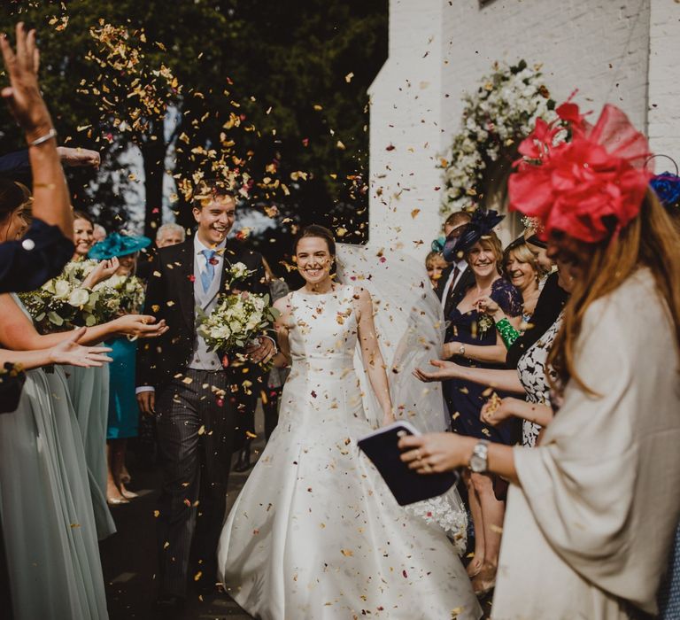 Bride and groom confetti exit