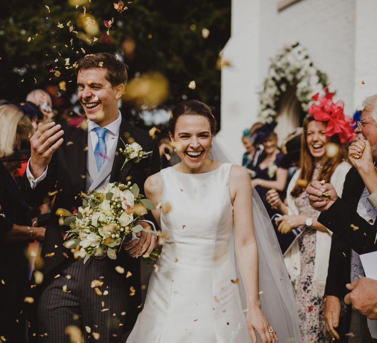 Bride and groom church confetti moment