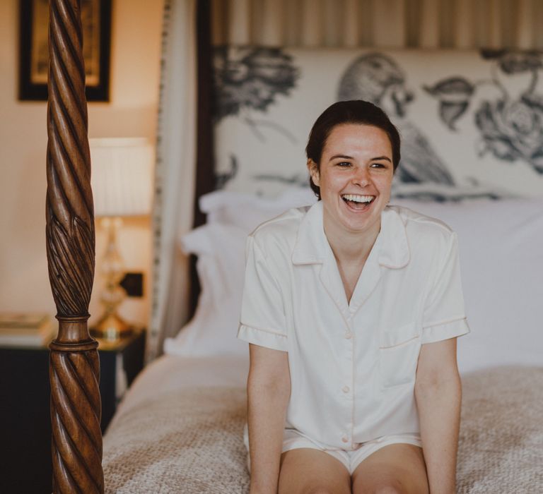 Bride in white pyjamas on wedding morning