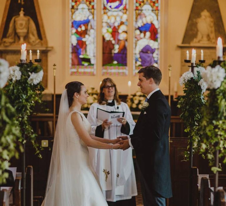 Bride and groom exchanging vows at the altar