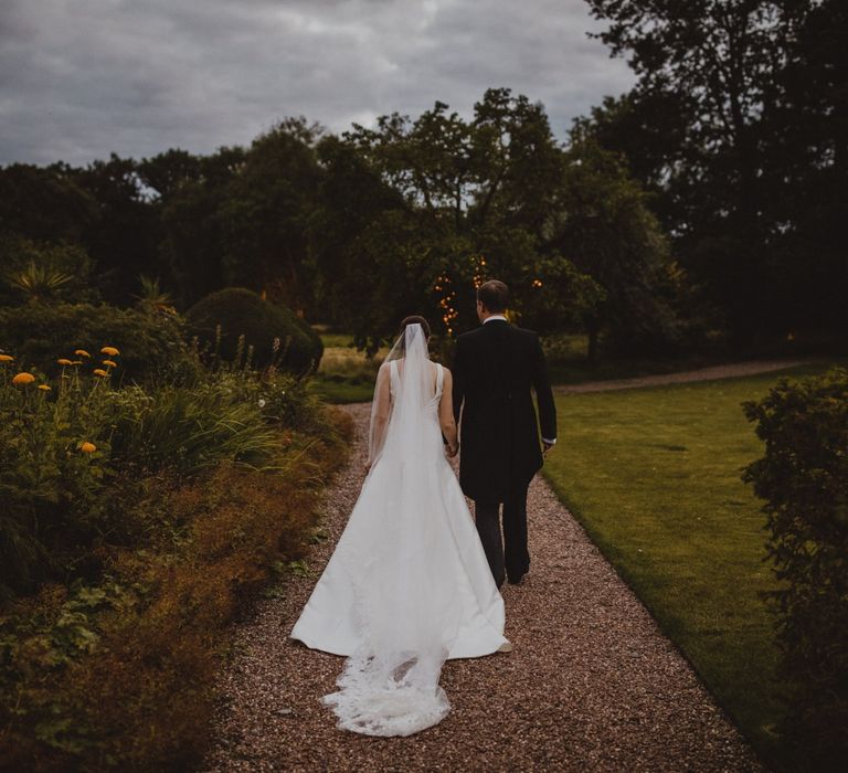 Bride in Pronovias wedding dress and groom in tail at Shropshire wedding venue