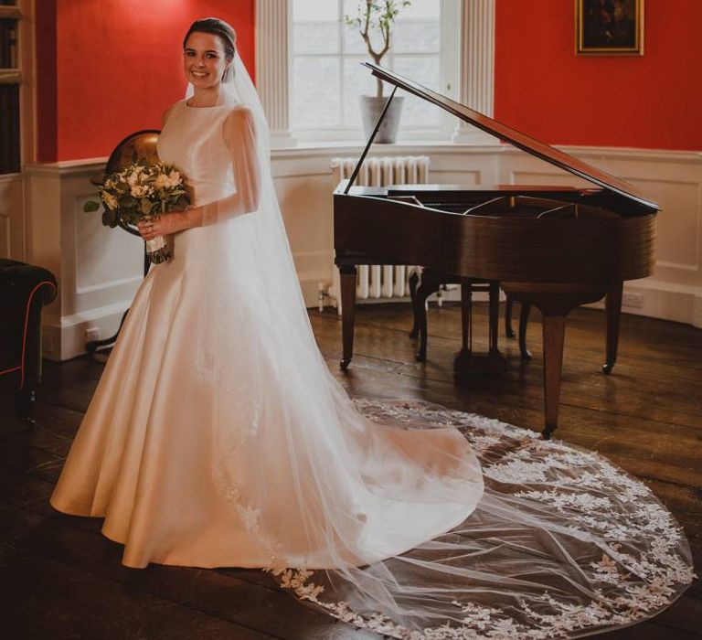 Bride in Pronovias wedding dress and lace edged cathedral length veil