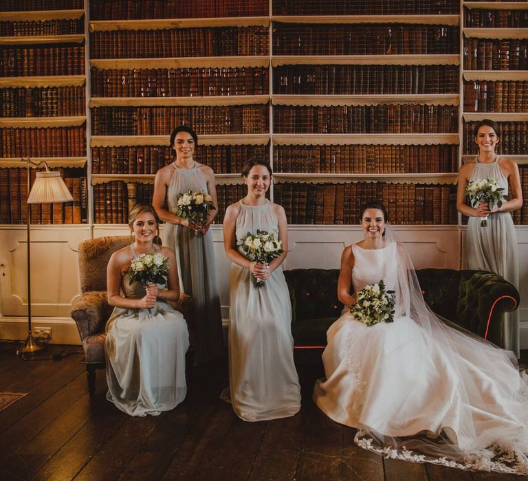 Bride and bridesmaids portrait in the library at Shropshire wedding venue, Iscoyd Park