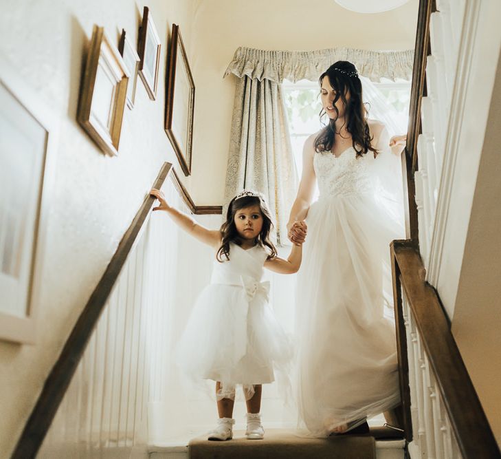 Bride makes her way to wedding ceremony in Watters wedding dress