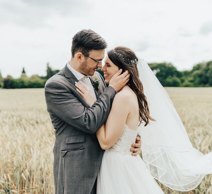 Bride in Watters wedding dress with groom in grey morning suit