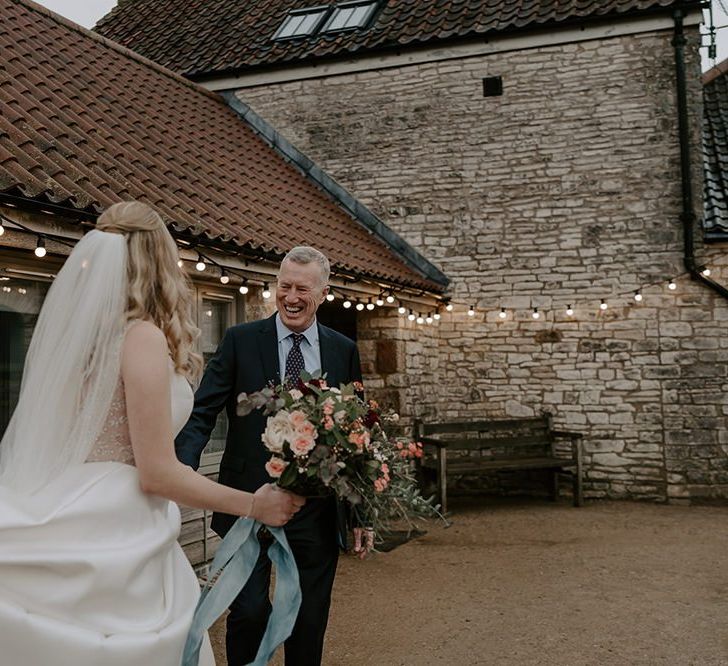 Bride wears veil as she makes her way to the ceremony