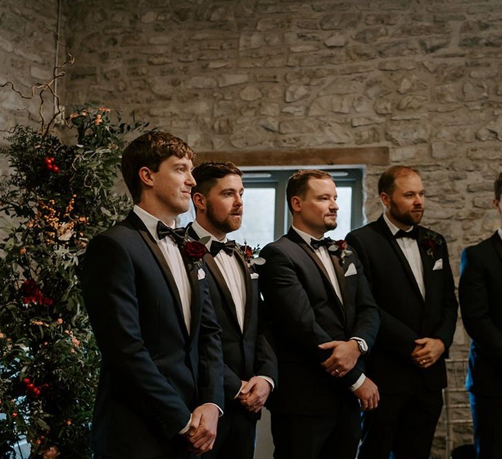 Groom with groomsmen as they wait for bride's arrival