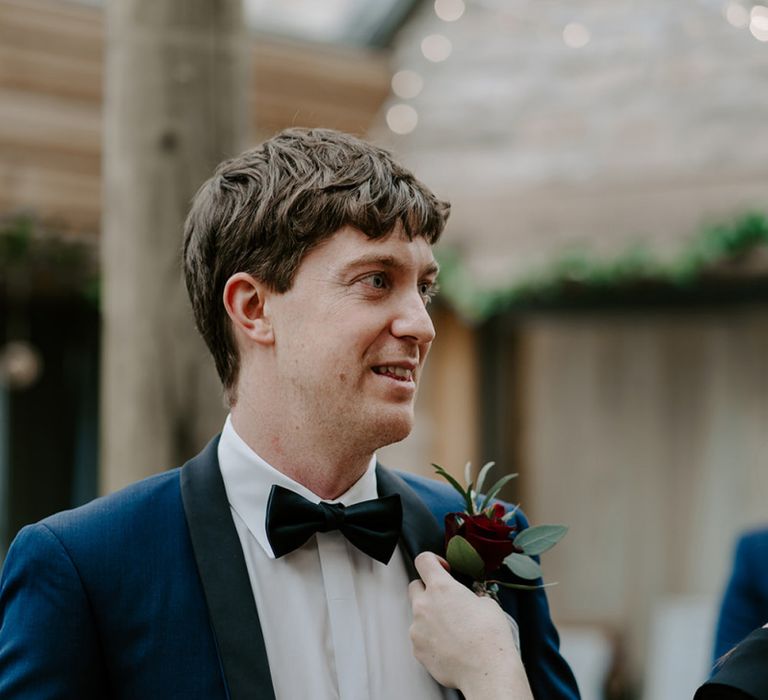 Groom in Navy blue tuxedo