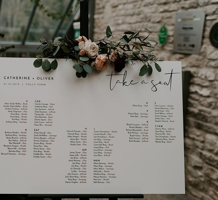 Wedding table plan and unplugged wedding sign decorated in flowers