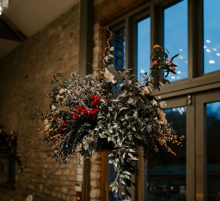 Tall flower centrepieces for tables at Winter wedding