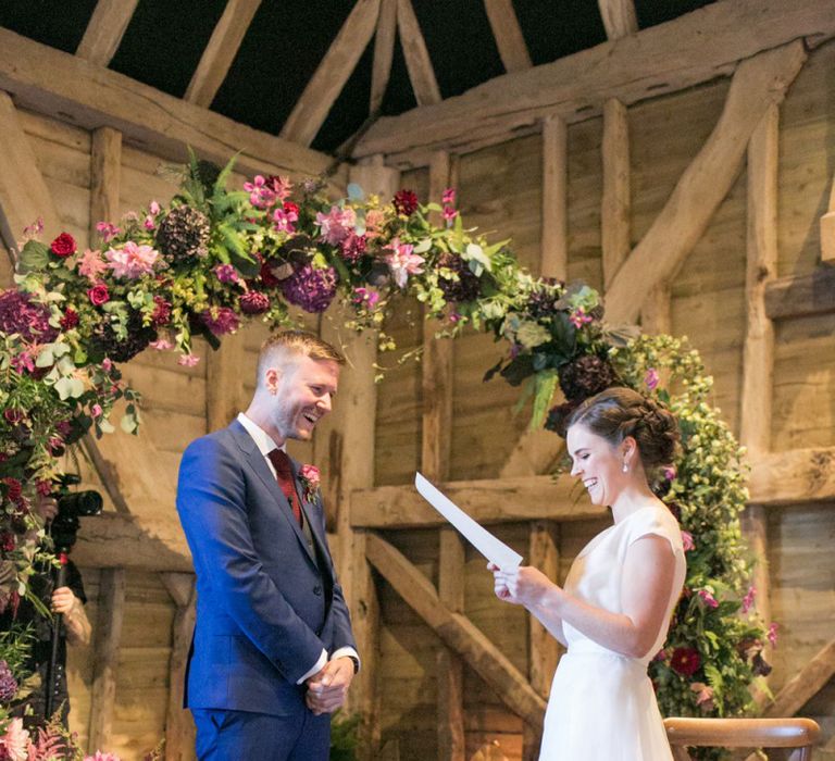 Bride in Jesus Peiro Wedding Dress and Groom in Blue  Hugo Boss Suit Saying Their Vows at The Moon Gate Altar