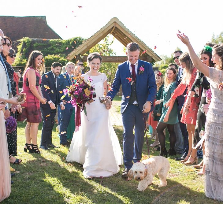 Confetti Moment with Bride in Jesus Peiro Wedding Dress and Groom in Blue  Hugo Boss Suit