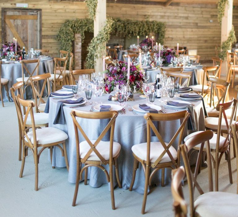 Rustic Barn Wedding Reception with Wooden Chairs and  Floral Centrepieces