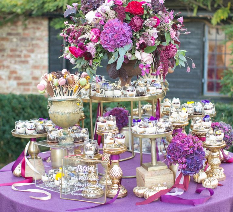 Dessert Table with Purple Table Cloth and Wedding Flowers