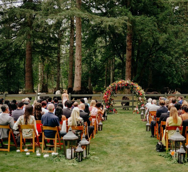 Outdoor wedding ceremony at Mystique Ranch with flower arch