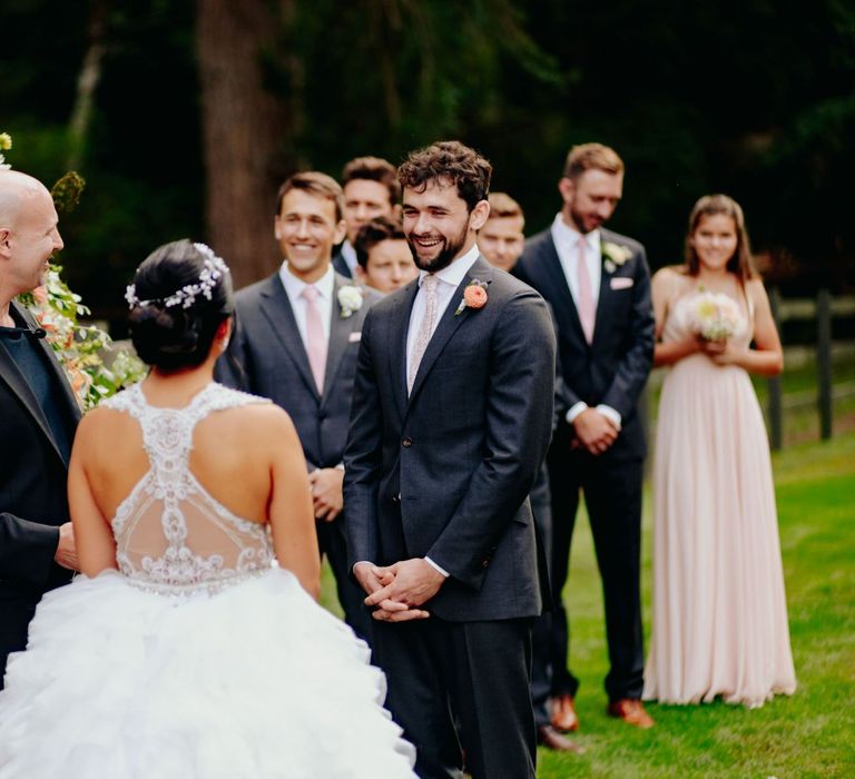 Bride in racer back wedding dress saying her vows