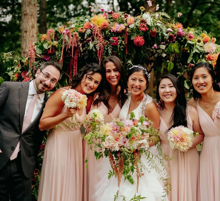 Bridal party portrait with bridesmaids in pink dresses