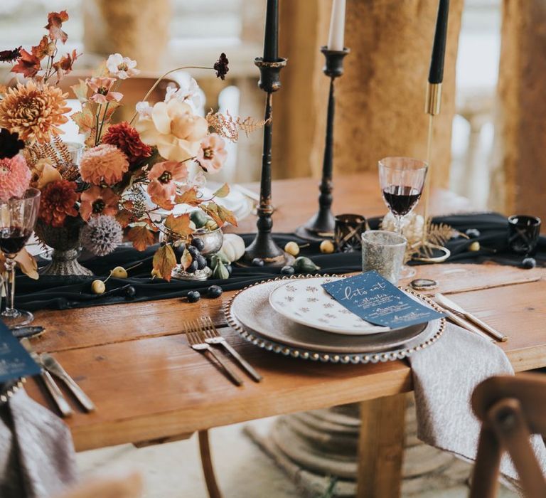 Place setting with charger plate, candles and celestial menu card