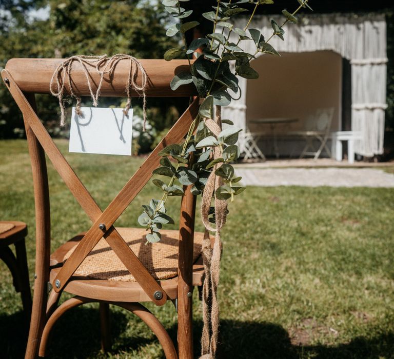 Wedding chair sign at outdoor ceremony for tipi wedding with donut wall and grazing table