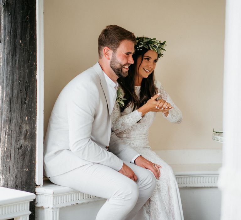 Bride and groom during outdoor ceremony at wedding with donut wall